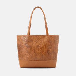 A structured tan leather tote bag with a crocodile-embossed texture on the main body, smooth leather trim and handles, and gold-tone hardware, shown against a light gray background.