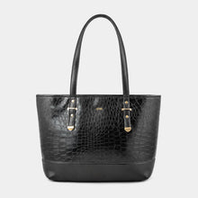 A black crocodile-embossed leather tote bag with dual top handles and gold-tone hardware, centered on a light gray background.