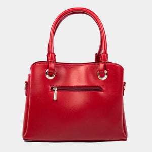 Red handbag with gold accents on a light gray background