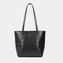 A black crocodile-embossed leather tote bag with dual shoulder straps and a small gold-tone logo plaque on the front, set against a solid light gray background.