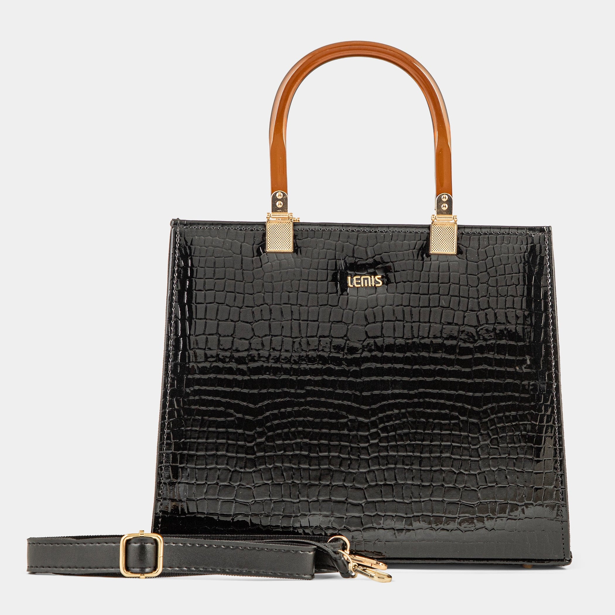 Black crocodile-patterned handbag with brown handle on a light gray background